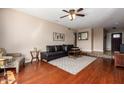 Well-lit living room featuring cherry floors, a comfortable leather sofa, and stylish décor at 16814 N 31St Ave, Phoenix, AZ 85053