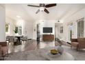 Open-concept living room with hardwood floors, ceiling fan, and a view into the kitchen space at 1825 W Ray Rd # 2111, Chandler, AZ 85224