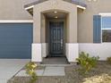 Close-up of a modern front door with a covered entryway and neutral-colored exterior at 20279 N 224Th Dr, Surprise, AZ 85387
