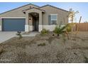 Inviting single story home with desert landscape, covered entry, and a two-car garage at 20279 N 224Th Dr, Surprise, AZ 85387