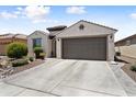 Inviting single-Gathering home with a spacious driveway, desert landscape, and a traditional architectural style at 21090 N 267Th Dr, Buckeye, AZ 85396