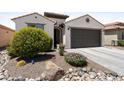 Well-maintained front yard with desert landscaping, decorative rocks, and a charming exterior at 21090 N 267Th Dr, Buckeye, AZ 85396