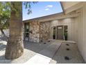 Charming front entry showcasing a stone wall and neutral paint, creating an inviting and appealing exterior at 211 W Braeburn Dr, Phoenix, AZ 85023