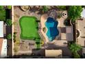 Aerial view featuring a backyard with a putting green, sparkling pool with a slide and hot tub at 21337 E Waverly Dr, Queen Creek, AZ 85142