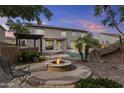 Inviting backyard featuring a fire pit, swimming pool, spa, and outdoor seating area at 21337 E Waverly Dr, Queen Creek, AZ 85142