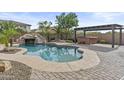 Resort-style pool with a slide, hot tub, pergola, and a well-manicured patio area at 21337 E Waverly Dr, Queen Creek, AZ 85142