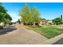 Beautiful home with well-manicured lawn and a charming driveway, perfect for suburban living at 2300 E Sanoque Ct, Gilbert, AZ 85298