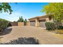 Spacious three-car garage and gated entrance on a paved driveway at 2300 E Sanoque Ct, Gilbert, AZ 85298