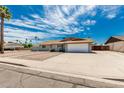 Street view of a single-story home with desert landscaping, showcasing its facade and curb appeal at 2327 E Pebble Beach Dr, Tempe, AZ 85282