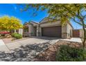 Beautiful one-story home with a two-car garage, landscaped front yard, and inviting walkway at 235 S 190Th Ave, Buckeye, AZ 85326