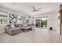 Spacious living room featuring neutral tones, large windows, modern tile floors and sliding glass doors at 235 S 190Th Ave, Buckeye, AZ 85326