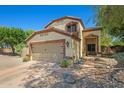 Charming two-story home featuring a two-car garage and desert landscaping at 2454 W Camp River Rd, Queen Creek, AZ 85144