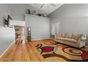 Bright living room with vaulted ceilings and hardwood flooring at 2454 W Camp River Rd, Queen Creek, AZ 85144
