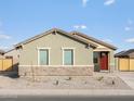 Charming single-story home with a red door and a well-maintained, low maintenance front yard at 2668 E San Miguel Dr, Casa Grande, AZ 85194