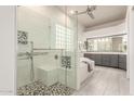 Modern bathroom with a glass shower, bench seating, and stylish gray vanity at 3001 E Winchcomb Dr, Phoenix, AZ 85032