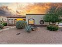 Charming home with desert landscaping, mature trees, and warm exterior lighting at 3001 E Winchcomb Dr, Phoenix, AZ 85032