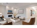 Bright living room with modern decor, fireplace, and ample seating at 3145 E Boot Track Trl, Gilbert, AZ 85296