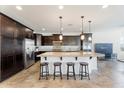 Bright kitchen with an island featuring pendant lighting, bar stool seating, and stainless steel appliances at 3394 E Tiffany Ct, Gilbert, AZ 85298