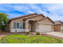 Well-kept single story house featuring a manicured lawn and a two-car garage, captured on a sunny day at 3971 E Heather Ct, Gilbert, AZ 85234