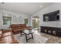 Bright and airy living room features tile flooring, comfortable seating, and sliding glass doors to the outdoor space at 4136 W Palace Station Rd, New River, AZ 85087