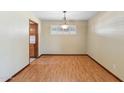 Inviting dining room with wood-look flooring, bright window, and classic chandelier at 4219 E Catalina Dr, Phoenix, AZ 85018