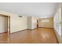 Bright living room with wood-look flooring, large windows, and ample natural light at 4219 E Catalina Dr, Phoenix, AZ 85018