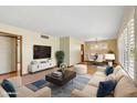 Cozy living room featuring a plush sofa, modern TV stand, and elegant decor for comfortable living at 4219 E Catalina Dr, Phoenix, AZ 85018