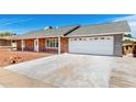 A charming single-story home with red brick, white trim, and a convenient two-car garage at 4310 E Sacaton St, Phoenix, AZ 85044