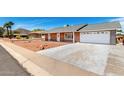 Inviting single-story brick home with well-maintained landscaping and a spacious two-car garage at 4310 E Sacaton St, Phoenix, AZ 85044