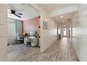 Hallway with wood-look tile flooring leading to home office with accent wall paint at 4512 S Ferric Ave, Mesa, AZ 85212