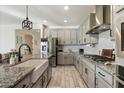 Modern kitchen features gray cabinets, granite countertops, and stainless steel appliances at 4512 S Ferric Ave, Mesa, AZ 85212