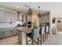Stylish kitchen with a center island, pendant lighting, and light gray cabinetry at 4512 S Ferric Ave, Mesa, AZ 85212