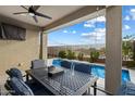 Cozy outdoor patio with dining area overlooking a refreshing blue swimming pool at 4512 S Ferric Ave, Mesa, AZ 85212