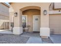 Close-up of the porch with stylish seating, decorative lighting, and a secure front door at 45543 W Guilder Ave, Maricopa, AZ 85139