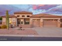 Beautiful beige home with a tile roof, 2-car garage, desert landscaping, and stone accents on the facade at 4615 S Primrose Dr, Gold Canyon, AZ 85118