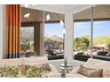 View from living room overlooking the backyard pool, patio, and desert landscaping at 5690 E Canyon Creek Cir, Carefree, AZ 85377