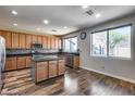 Well-lit kitchen featuring wooden cabinets, dark granite countertops, and stainless steel appliances at 5826 W Plum Rd, Phoenix, AZ 85083