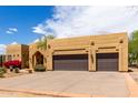 Single story home featuring desert landscaping with blooming flowers, and an attached two-car garage at 5978 E Chuckwalla Trl, Cave Creek, AZ 85331