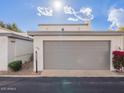 View of the garage with beautiful flowering shrubs. Number 6130 clearly visible at 6130 N 12Th Way, Phoenix, AZ 85014