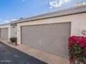 Image of attached garage with blooming flowers; low maintenance landscaping, blue sky at 6130 N 12Th Way, Phoenix, AZ 85014