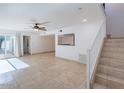 Spacious living room featuring tiled flooring, sliding glass doors, and staircase at 6130 N 12Th Way, Phoenix, AZ 85014