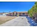 Inviting single-story home featuring a well-maintained yard and long driveway and desert landscaping at 6939 W Cambridge Ave, Phoenix, AZ 85035
