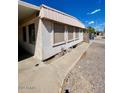 Exterior view of home featuring covered parking on side at 7214 S 42Nd St, Phoenix, AZ 85042