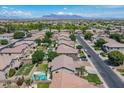 Expansive aerial view of a residential neighborhood with lush greenery and a mountain backdrop at 10234 E Lomita Ave, Mesa, AZ 85209