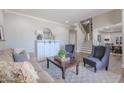 Cozy living room featuring neutral tones, a comfortable sofa, chairs, and a staircase at 10234 E Lomita Ave, Mesa, AZ 85209