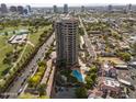 An aerial view of a high rise building with swimming pool, landscaping and city views at 1040 E Osborn Rd # 1103, Phoenix, AZ 85014