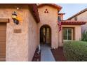 Inviting front porch with desert landscaping and charming details around the front door and light fixture at 10850 W Bronco Trl, Peoria, AZ 85383
