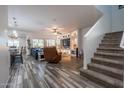 Spacious living room featuring a built-in entertainment center and view of the staircase at 10850 W Bronco Trl, Peoria, AZ 85383