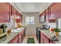 Efficient kitchen with granite countertops, modern appliances, and ample cabinet space at 1243 E Susan Ln, Tempe, AZ 85288