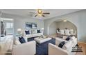 Bright living room with neutral tones, stylish furniture, and arched entryway to the dining area at 1243 E Susan Ln, Tempe, AZ 85288